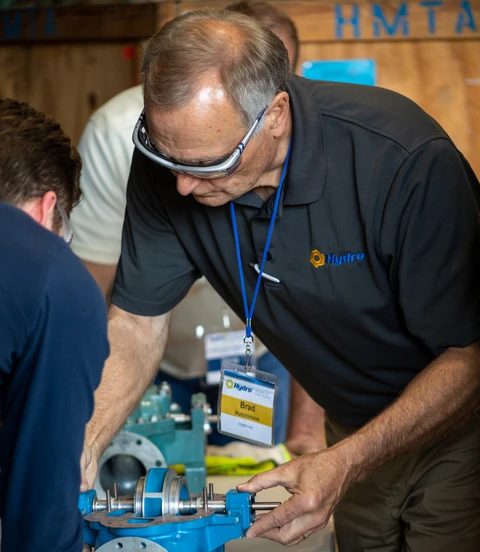 Instructor guiding hands-on pump training